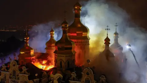 Russian airstrikes kill 11 and set Kyiv's historic Dormition Cathedral ablaze