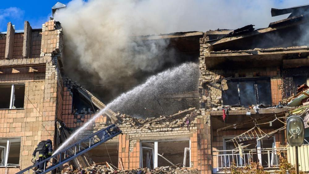 Drone strike on a residential building in Kharkiv; emergency services respond