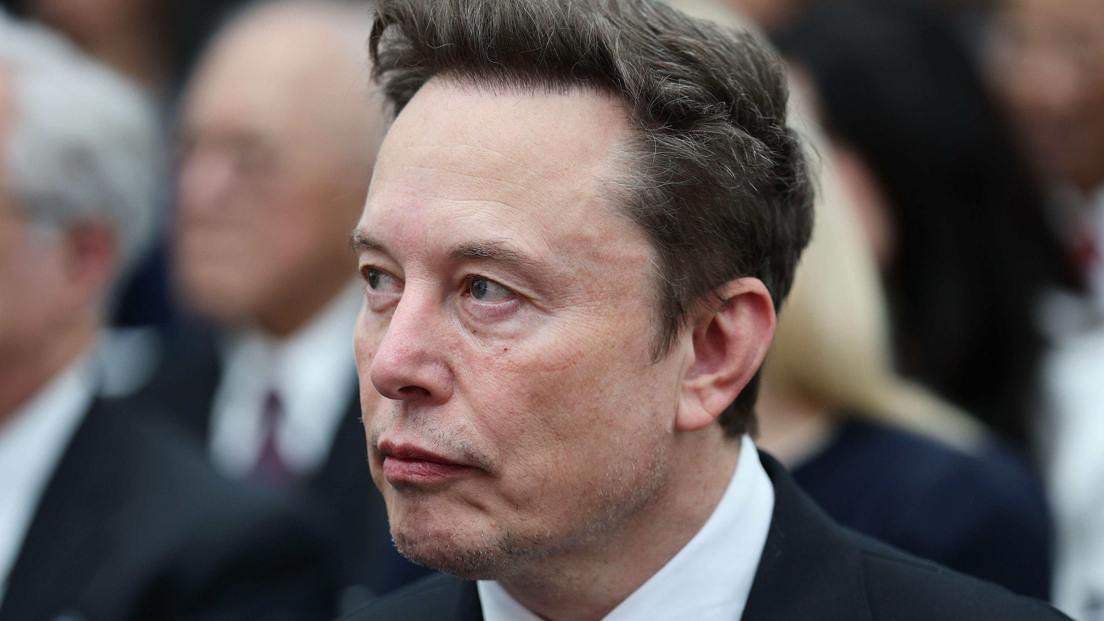 Elon Musk in a dark suit