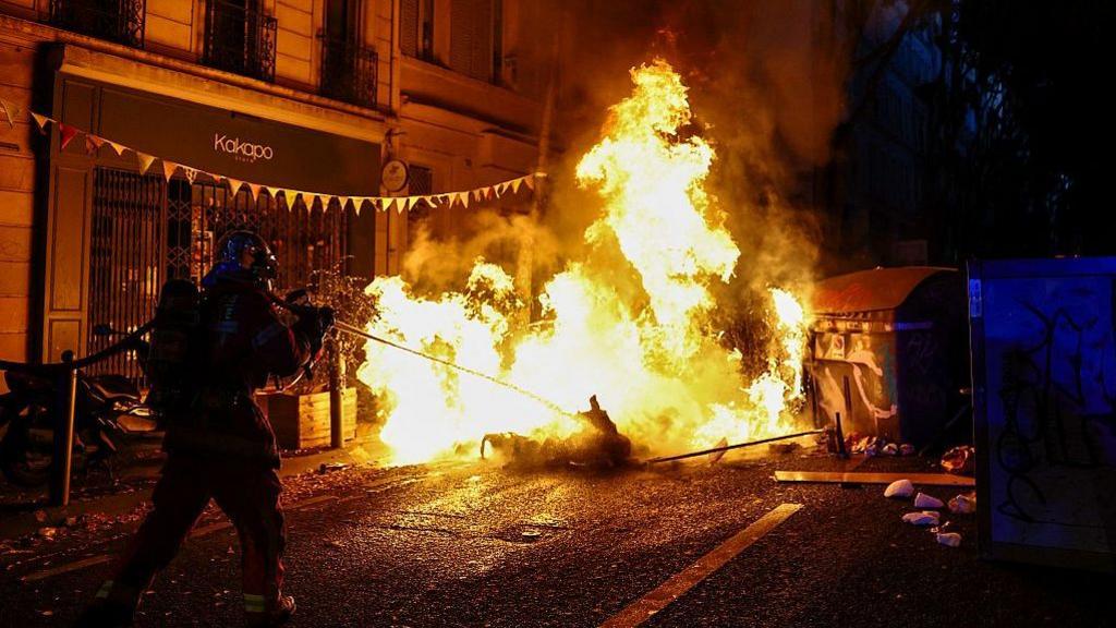A burning makeshift street barricade in Marseille during protests