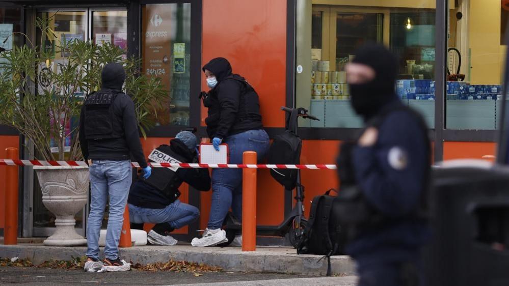 French police inspect the scene of the shooting in Trappes, near Paris
