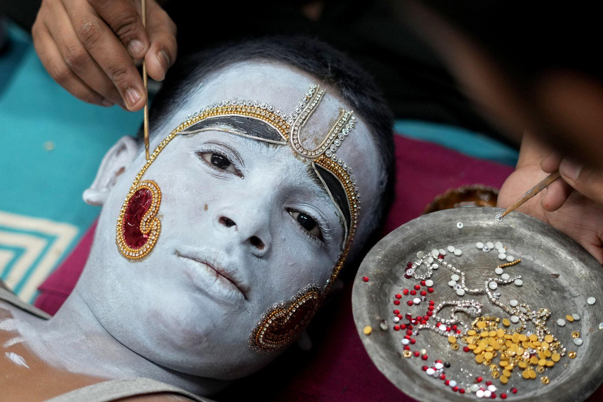 Artist painting face for a Ramlila performance